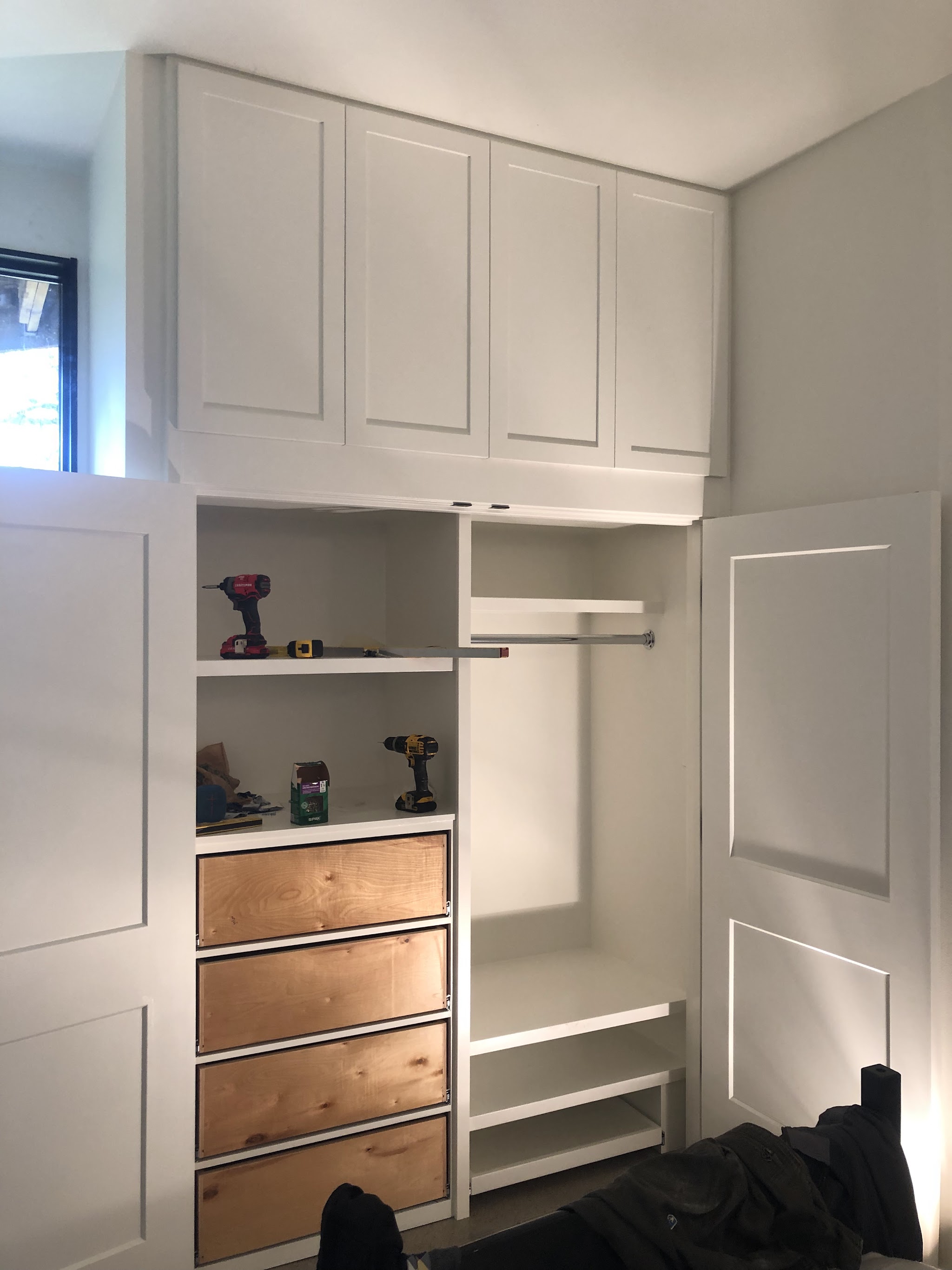 Custom built-in closet cabinetry with maple drawer fronts