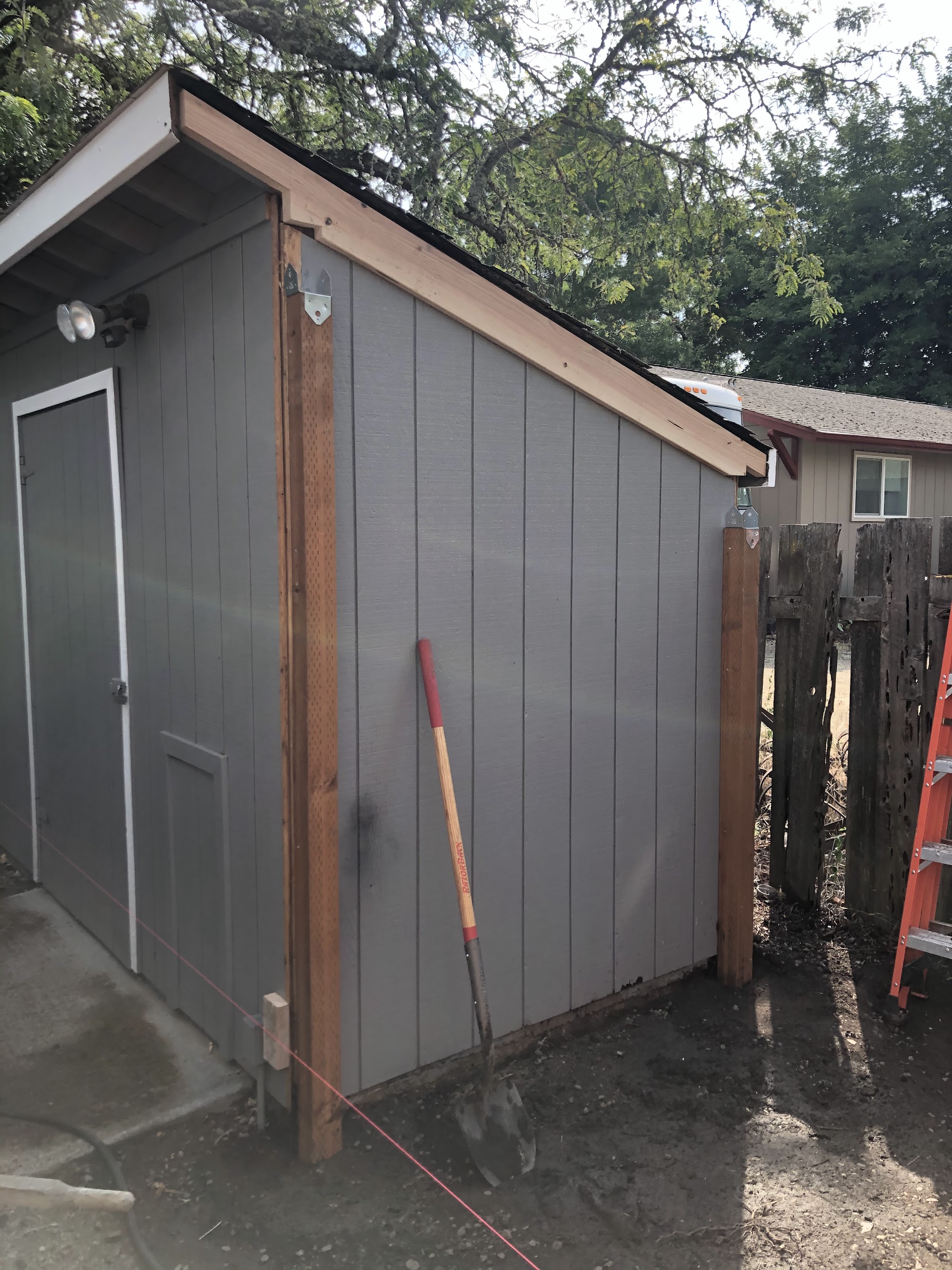Trim and fascia being installed on a backyard shed